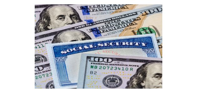 Social security card laying on a pile of 100 dollar bills